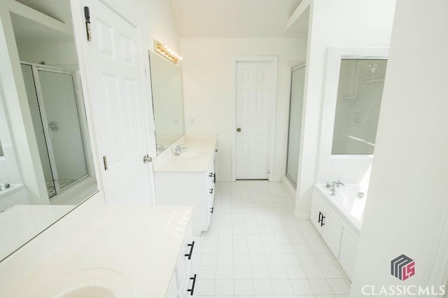 1851 Harvest Way, Loganville, GA 30052 - bathroom with two vanities, a stall shower, a garden tub, and tile patterned flooring