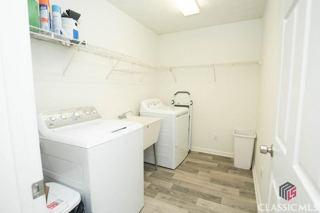 1851 Harvest Way, Loganville, GA 30052 - laundry area with washing machine and dryer and light wood-type flooring