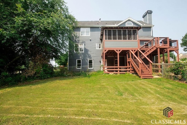 1851 Harvest Way, Loganville, GA 30052 - rear view of house featuring a chimney, a sunroom, a wooden deck, and stairs