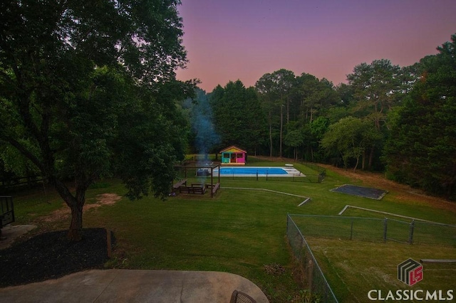 1851 Harvest Way, Loganville, GA 30052 - yard at dusk featuring an outdoor structure