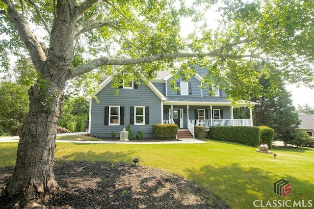 1851 Harvest Way, Loganville, GA 30052 - view of front facade with a porch and a front yard
