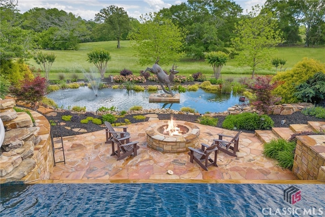 3881 Sims Bridge Rd, Monroe, GA 30656 - view of pool featuring a fire pit, a patio, view of wooded area, and a garden pond