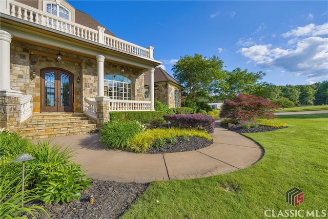 3881 Sims Bridge Rd, Monroe, GA 30656 - entrance to property with stone siding, french doors, covered porch, and a lawn