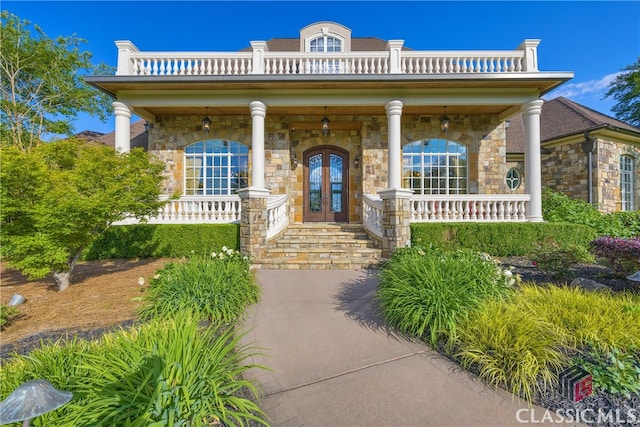 3881 Sims Bridge Rd, Monroe, GA 30656 - entrance to property with french doors, a porch, stone siding, and a balcony