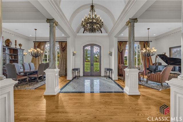 3881 Sims Bridge Rd, Monroe, GA 30656 - foyer entrance with a chandelier, decorative columns, french doors, light wood finished floors, and ornamental molding