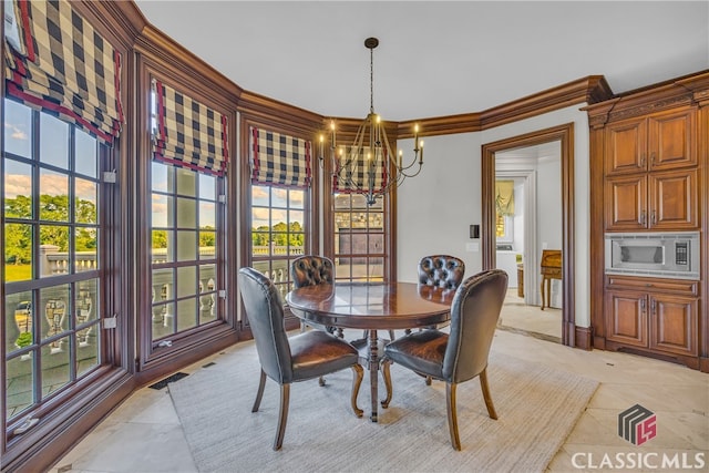 3881 Sims Bridge Rd, Monroe, GA 30656 - dining space with a chandelier, ornamental molding, and light tile patterned floors
