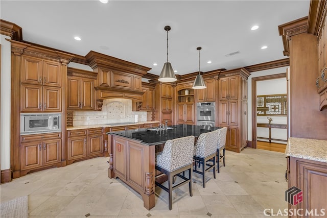 3881 Sims Bridge Rd, Monroe, GA 30656 - kitchen featuring stainless steel microwave, brown cabinets, a breakfast bar area, a sink, and recessed lighting