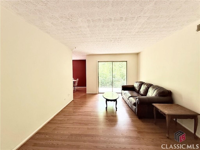 168 Scandia Cir, Athens, GA 30605 - living room with wood finished floors, a textured ceiling, and baseboards