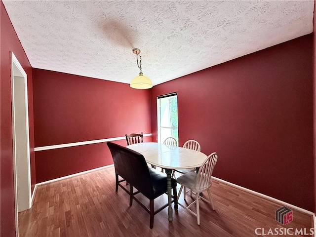 168 Scandia Cir, Athens, GA 30605 - dining room with a textured ceiling, wood finished floors, and baseboards