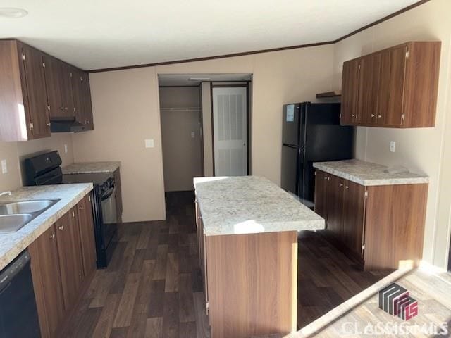 832 Stone Stewart Rd, Hull, GA 30646 - kitchen featuring black appliances, dark wood-type flooring, a center island, light countertops, and ornamental molding