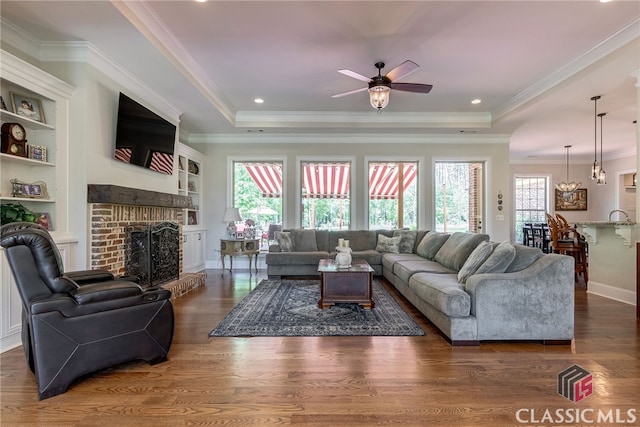 1641 Lane Creek Rd, Bogart, GA 30622 - living room featuring ceiling fan, a raised ceiling, a fireplace, wood finished floors, and crown molding