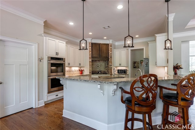 1641 Lane Creek Rd, Bogart, GA 30622 - kitchen featuring stainless steel appliances, backsplash, recessed lighting, light stone counters, and a breakfast bar