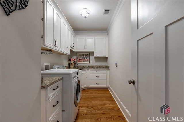 1641 Lane Creek Rd, Bogart, GA 30622 - laundry room featuring cabinet space, separate washer and dryer, ornamental molding, and light wood-style flooring
