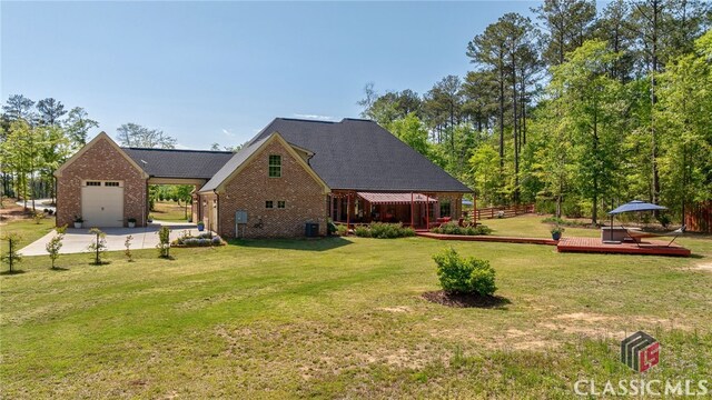 1641 Lane Creek Rd, Bogart, GA 30622 - view of home's exterior featuring brick siding, an attached garage, a wooden deck, and concrete driveway