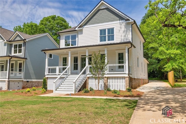 231 Marable St E, Monroe, GA 30655 - view of front of house featuring covered porch, stairs, a front yard, and driveway