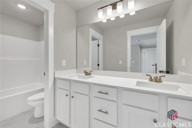 231 Marable St E, Monroe, GA 30655 - full bathroom featuring double vanity, toilet, marble look tiles, and tub / shower combination