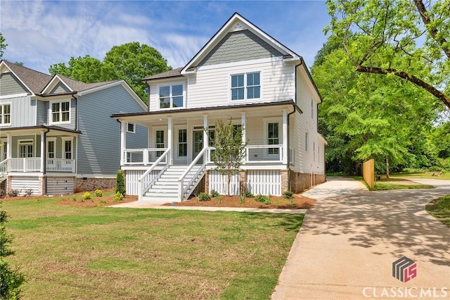 231 Marable St E, Monroe, GA 30655 - view of front of property with covered porch, driveway, a front lawn, and stairway