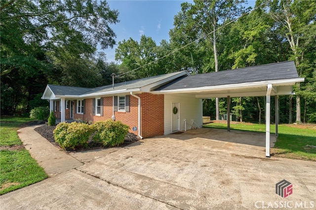 1210 Burr Harris Rd, Watkinsville, GA 30677 - ranch-style home featuring concrete driveway, brick siding, a carport, and a front yard
