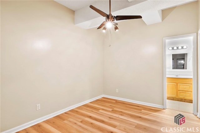 131 E Broad St Unit 506, Athens, GA 30601 - unfurnished room featuring ceiling fan, light wood finished floors, baseboards, and a sink