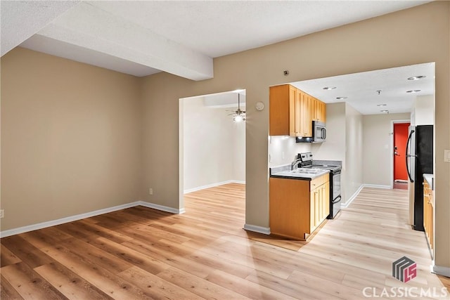 131 E Broad St Unit 506, Athens, GA 30601 - kitchen featuring appliances with stainless steel finishes, light wood finished floors, baseboards, and ceiling fan