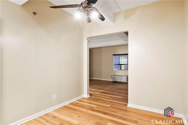 131 E Broad St Unit 506, Athens, GA 30601 - spare room featuring ceiling fan, light wood-style floors, baseboards, and an AC wall unit