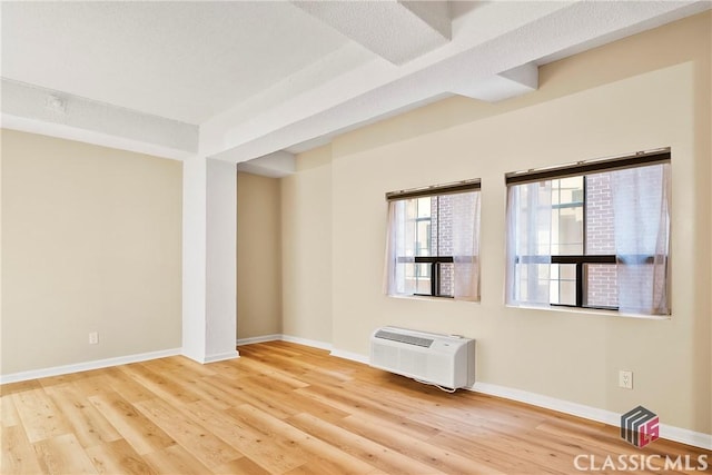 131 E Broad St Unit 506, Athens, GA 30601 - spare room with a wall unit AC, wood finished floors, and baseboards