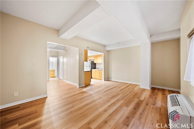 131 E Broad St Unit 506, Athens, GA 30601 - unfurnished living room with beamed ceiling, light wood-style flooring, and baseboards