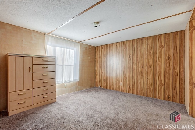 1200 Burr Harris Rd, Watkinsville, GA 30677 - empty room featuring carpet, wooden walls, and a textured ceiling