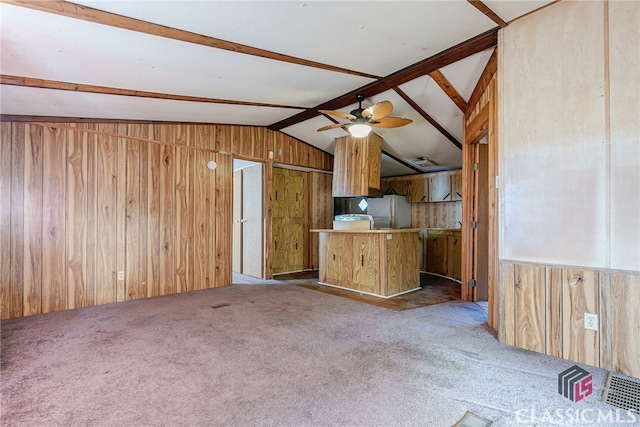 1200 Burr Harris Rd, Watkinsville, GA 30677 - kitchen featuring wood walls, lofted ceiling, carpet, ceiling fan, and fridge