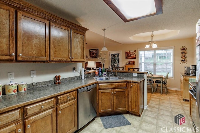 1663 Oconee Pt, Jefferson, GA 30549 - kitchen with stainless steel dishwasher, a sink, a peninsula, a tray ceiling, and decorative light fixtures