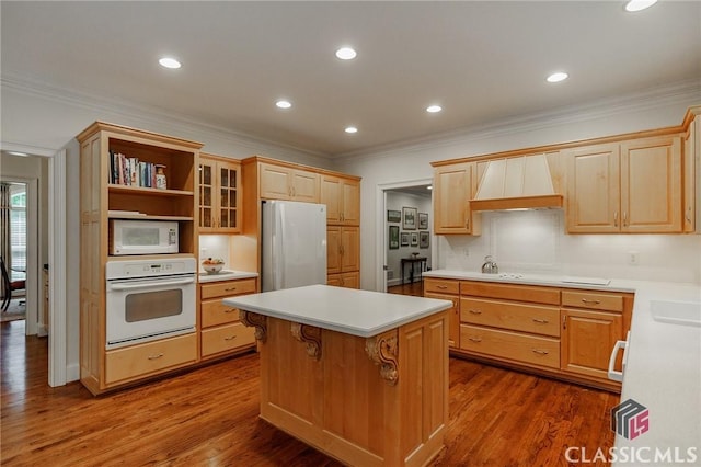 1181 Knob Creek Dr, Athens, GA 30606 - kitchen featuring white appliances, ornamental molding, custom exhaust hood, light countertops, and a kitchen island