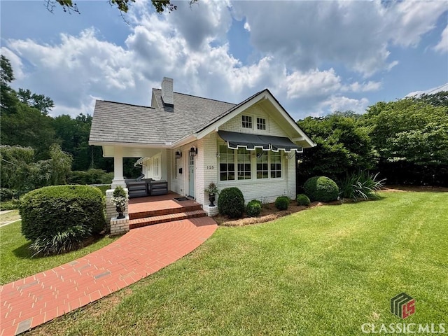 125 Woodland Way, Athens, GA 30606 - view of front of home with a front yard, brick siding, roof with shingles, and a chimney