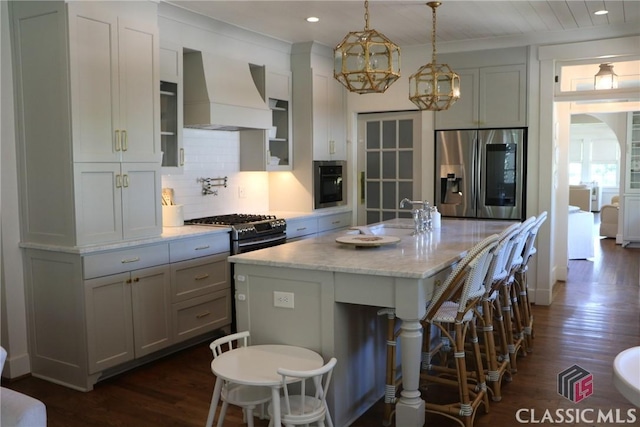 125 Woodland Way, Athens, GA 30606 - kitchen with stainless steel appliances, custom range hood, dark wood-type flooring, a breakfast bar area, and recessed lighting