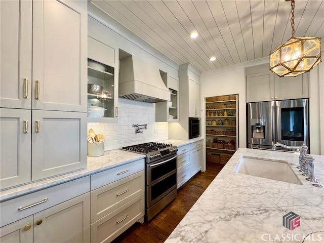 125 Woodland Way, Athens, GA 30606 - kitchen with stainless steel appliances, custom range hood, a sink, dark wood finished floors, and light stone countertops