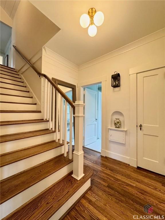 125 Woodland Way, Athens, GA 30606 - stairway with wood finished floors, a chandelier, crown molding, and baseboards