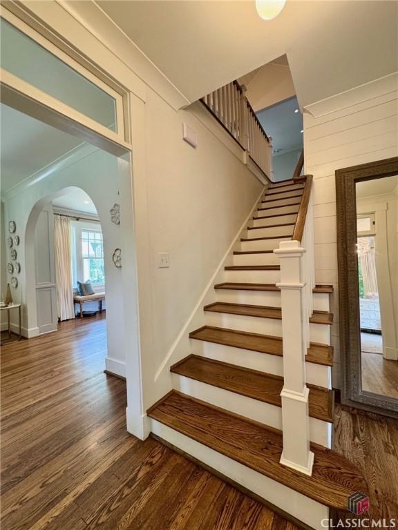 125 Woodland Way, Athens, GA 30606 - staircase featuring wood finished floors, arched walkways, ornamental molding, and baseboards