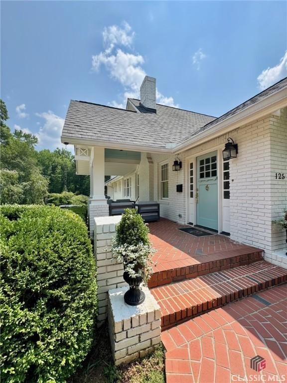 125 Woodland Way, Athens, GA 30606 - entrance to property featuring brick siding, a chimney, and a shingled roof