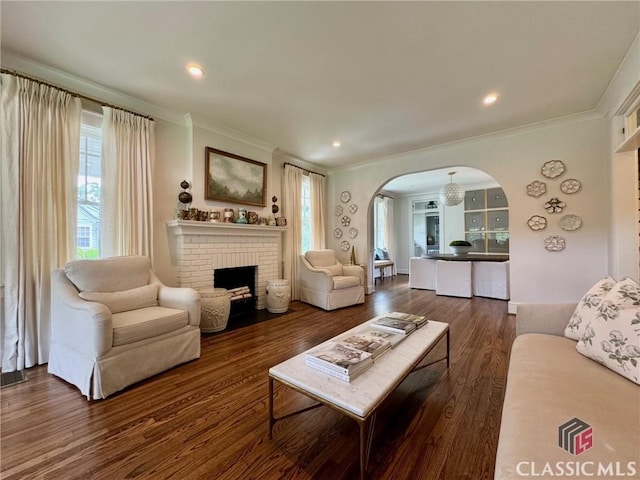 125 Woodland Way, Athens, GA 30606 - living area with ornamental molding, arched walkways, dark wood-style flooring, plenty of natural light, and a fireplace