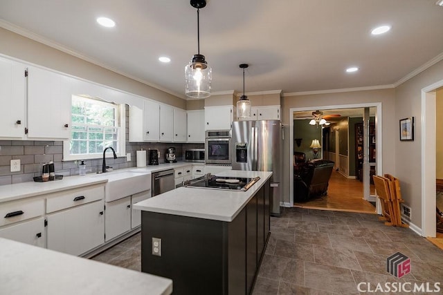 226 Baker St, Statham, GA 30666 - kitchen with appliances with stainless steel finishes, ornamental molding, white cabinetry, light countertops, and decorative backsplash