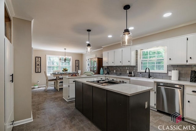 226 Baker St, Statham, GA 30666 - kitchen with dishwasher, black electric stovetop, plenty of natural light, light countertops, and ornamental molding