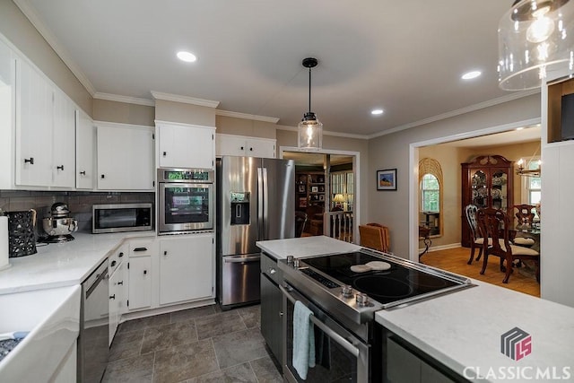 226 Baker St, Statham, GA 30666 - kitchen featuring appliances with stainless steel finishes, light countertops, white cabinets, pendant lighting, and recessed lighting