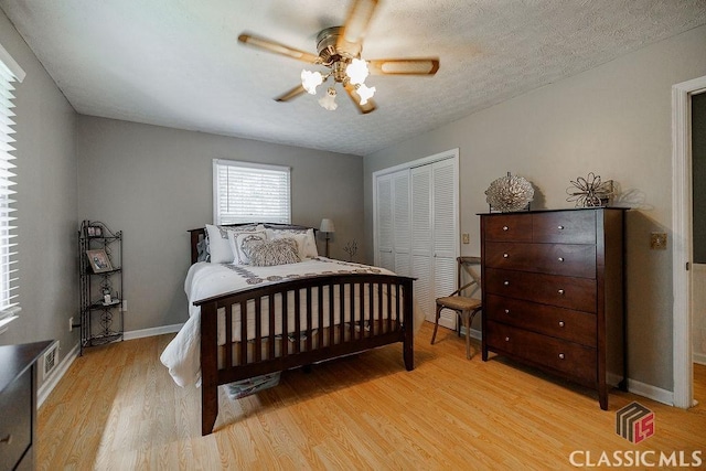 226 Baker St, Statham, GA 30666 - bedroom with light wood finished floors, a closet, and a ceiling fan