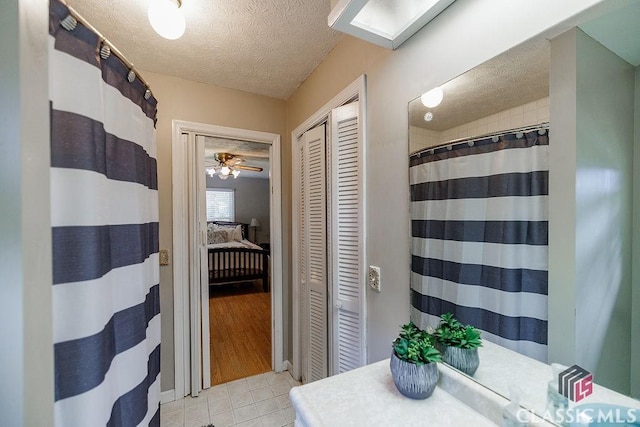 226 Baker St, Statham, GA 30666 - bathroom featuring a closet, a textured ceiling, tile patterned flooring, and curtained shower