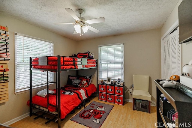 226 Baker St, Statham, GA 30666 - bedroom featuring wood finished floors, a textured ceiling, a closet, and ceiling fan