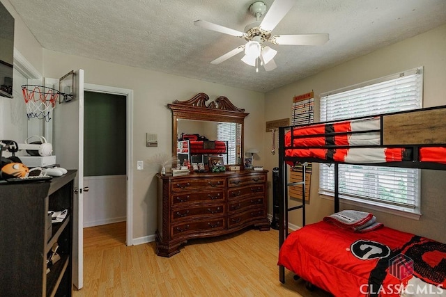 226 Baker St, Statham, GA 30666 - bedroom featuring wood finished floors, multiple windows, a textured ceiling, and ceiling fan