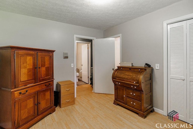 226 Baker St, Statham, GA 30666 - bedroom featuring light wood-style floors, a textured ceiling, and a closet