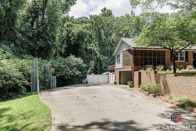 226 Baker St, Statham, GA 30666 - view of side of property featuring brick siding and concrete driveway