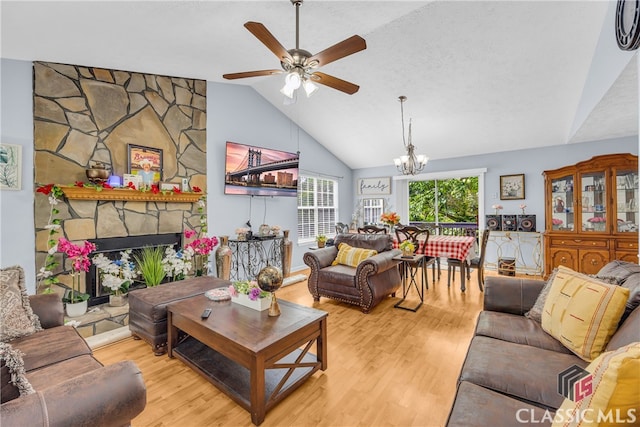 5480 Apache Trl, Gainesville, GA 30506 - living area with a chandelier, wood finished floors, a ceiling fan, a fireplace, and high vaulted ceiling