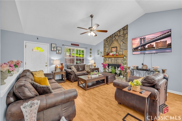 5480 Apache Trl, Gainesville, GA 30506 - living room featuring ceiling fan, light wood-style flooring, a stone fireplace, and high vaulted ceiling