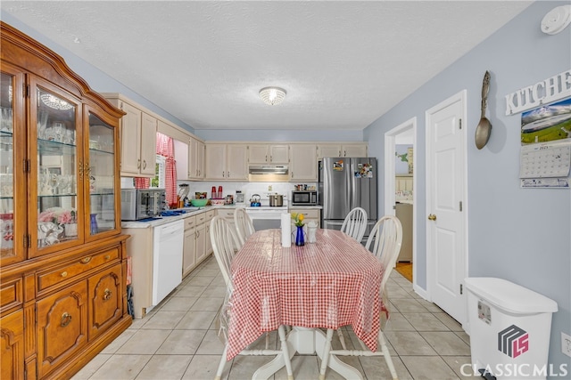 5480 Apache Trl, Gainesville, GA 30506 - kitchen featuring stainless steel appliances, light countertops, light tile patterned flooring, glass insert cabinets, and under cabinet range hood